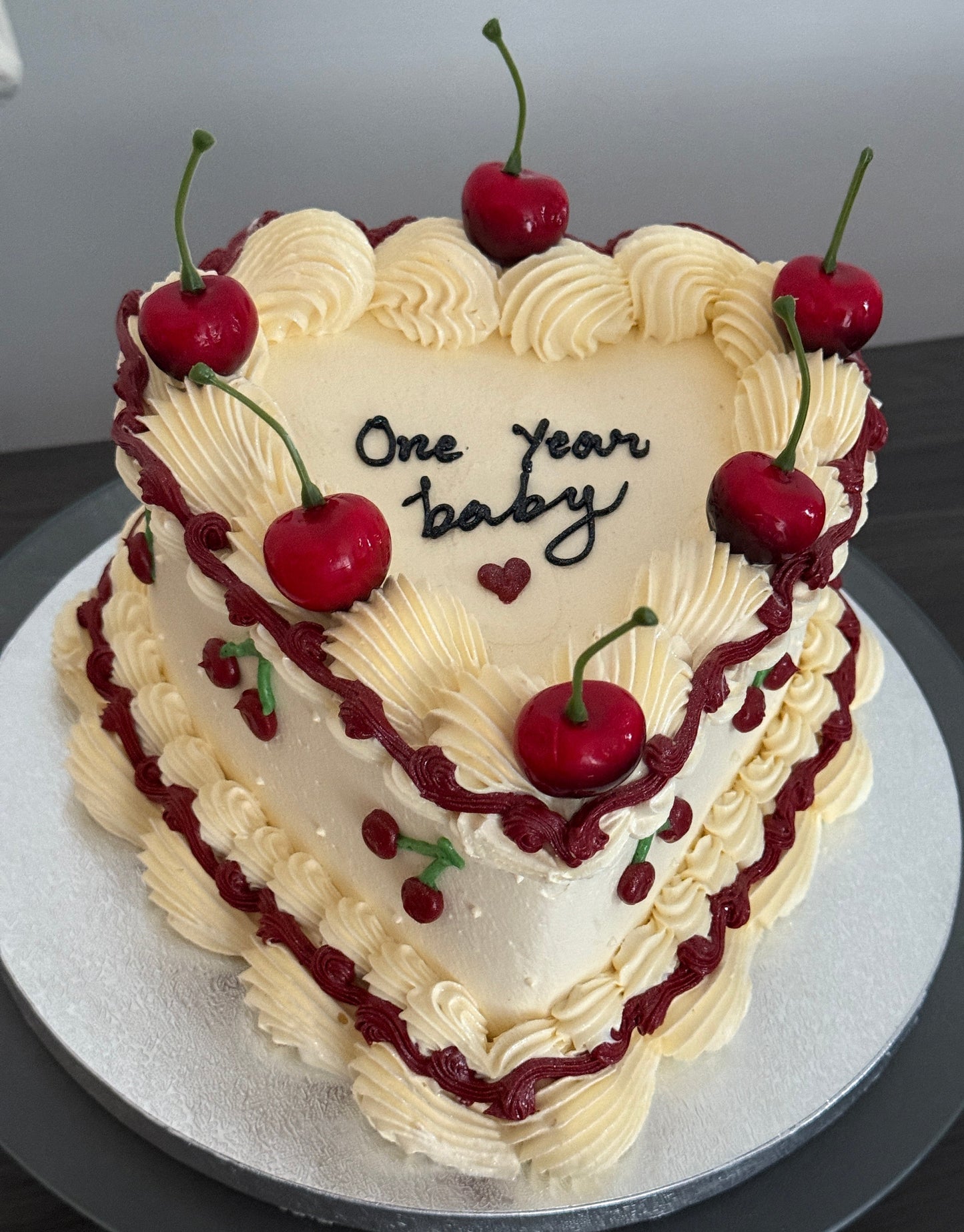 Cherry vintage heart cake with fresh cherries, buttercream piping, and red swirls – available for anniversary and birthday celebrations with same day delivery in Romford, Ilford, and East London.