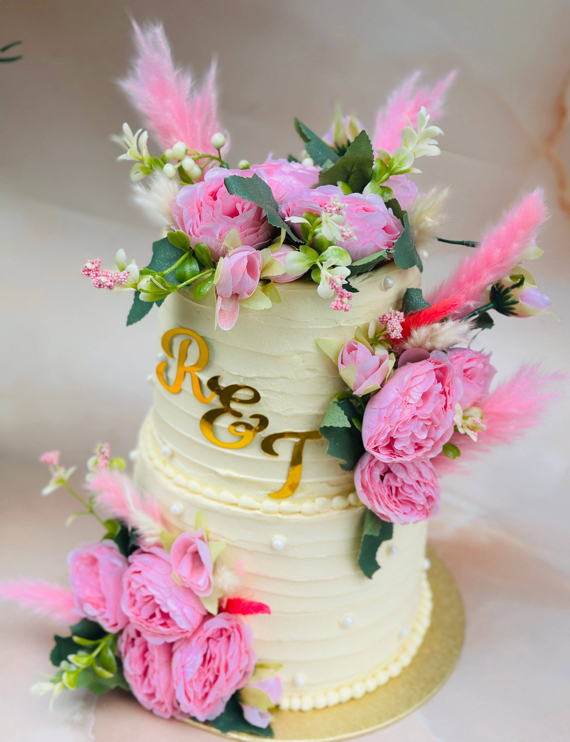 Order floral wedding cake with personalised initials and decorative blooms, available for Hainault and Woodford couples.