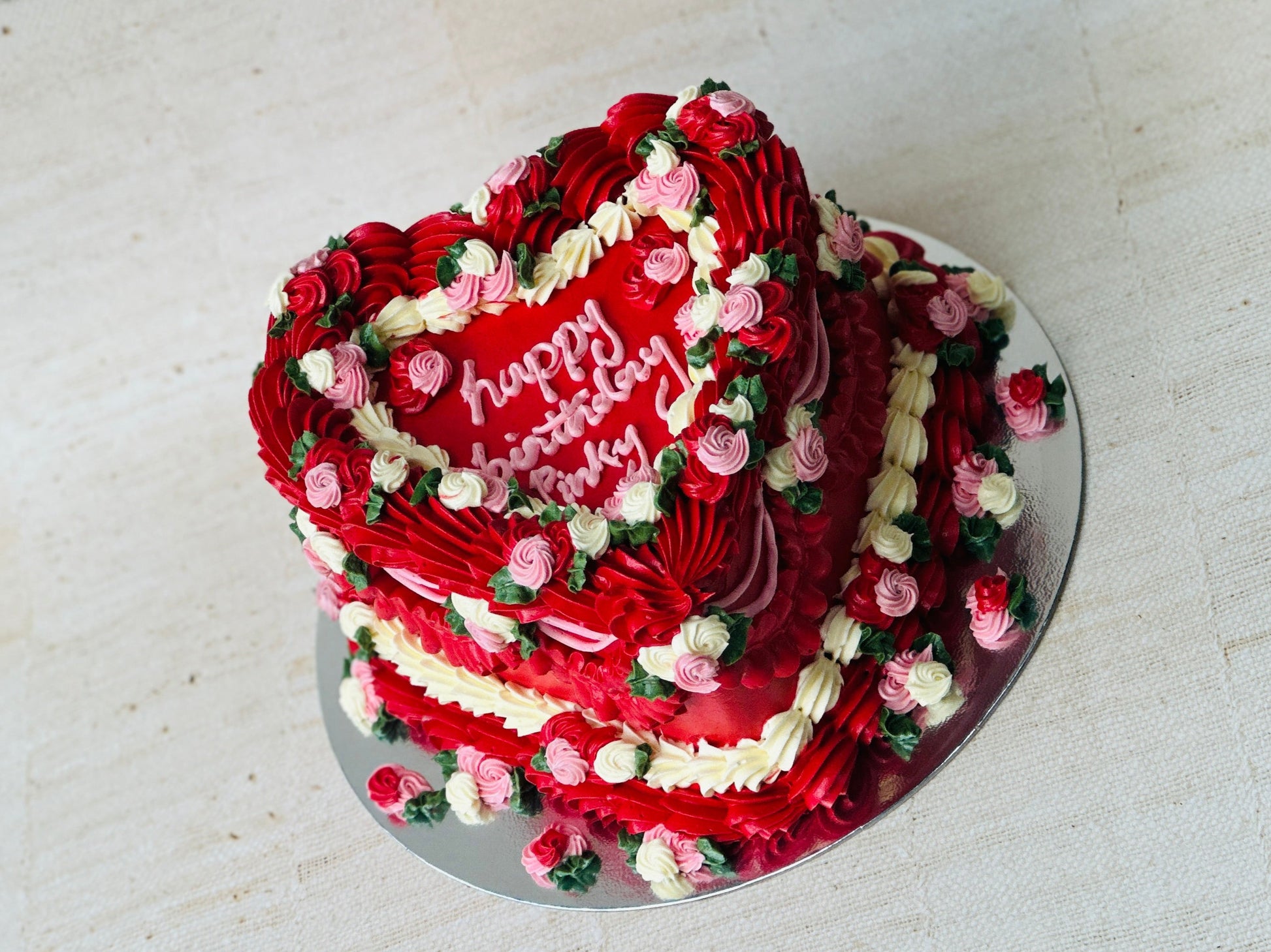 Order red heart birthday cake online with delivery in Dagenham and East London – elegant layered design with roses.