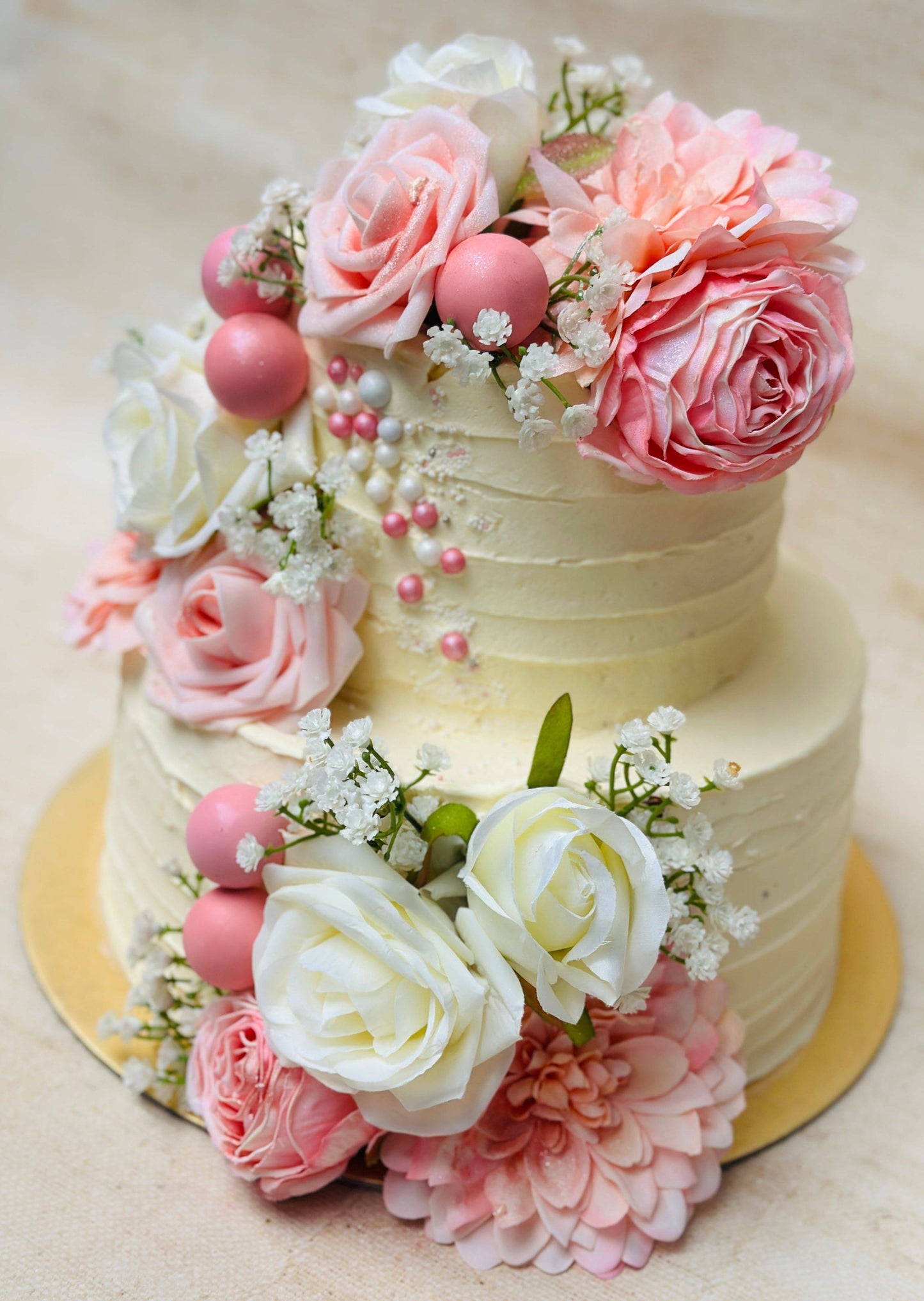 Rose garden wedding cake decorated with soft pink and white roses, available for wedding delivery in Romford and Ilford.