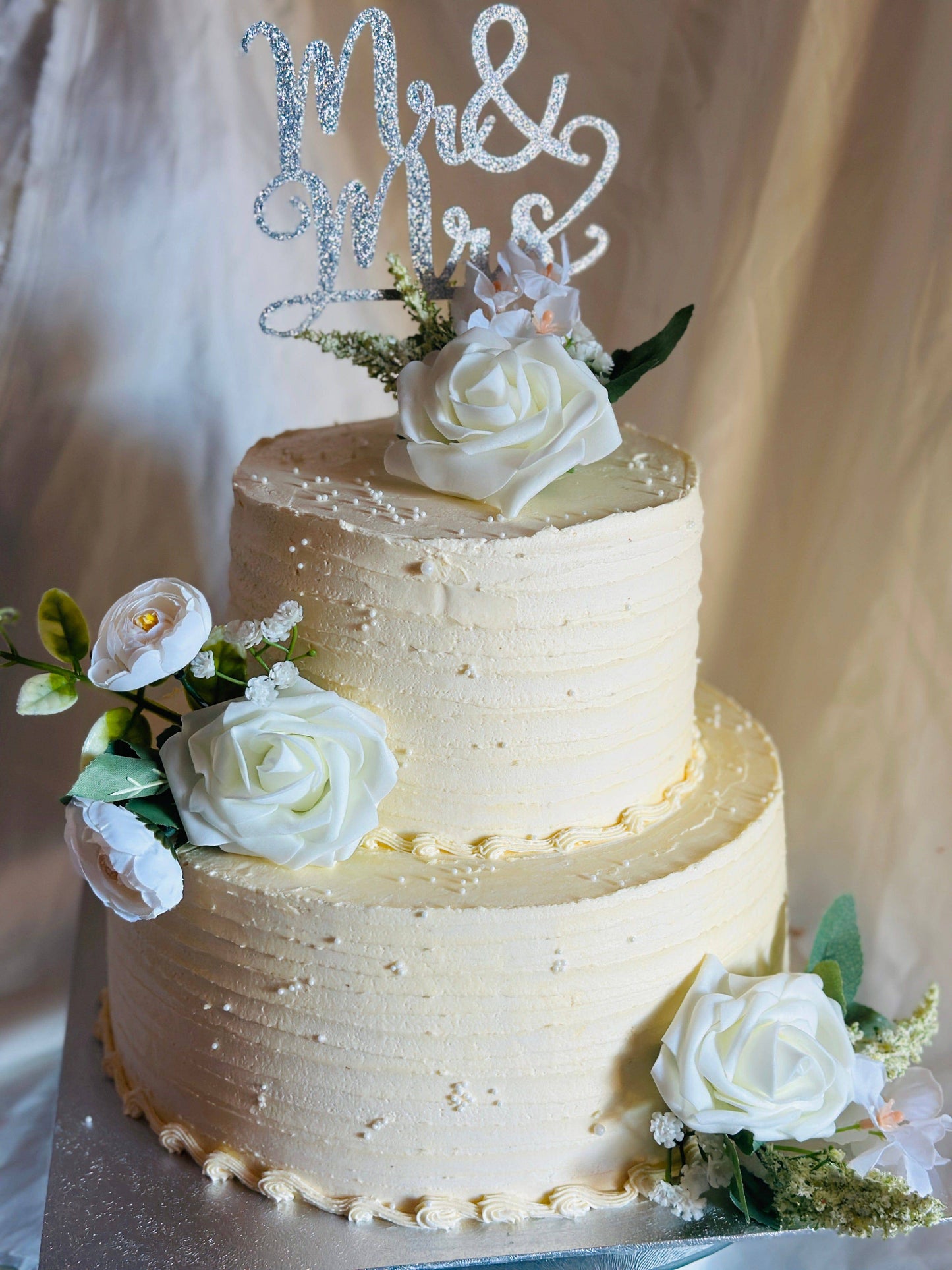 Rustic chic wedding cake with buttercream finish and white roses, available for delivery in Romford and South Woodford.