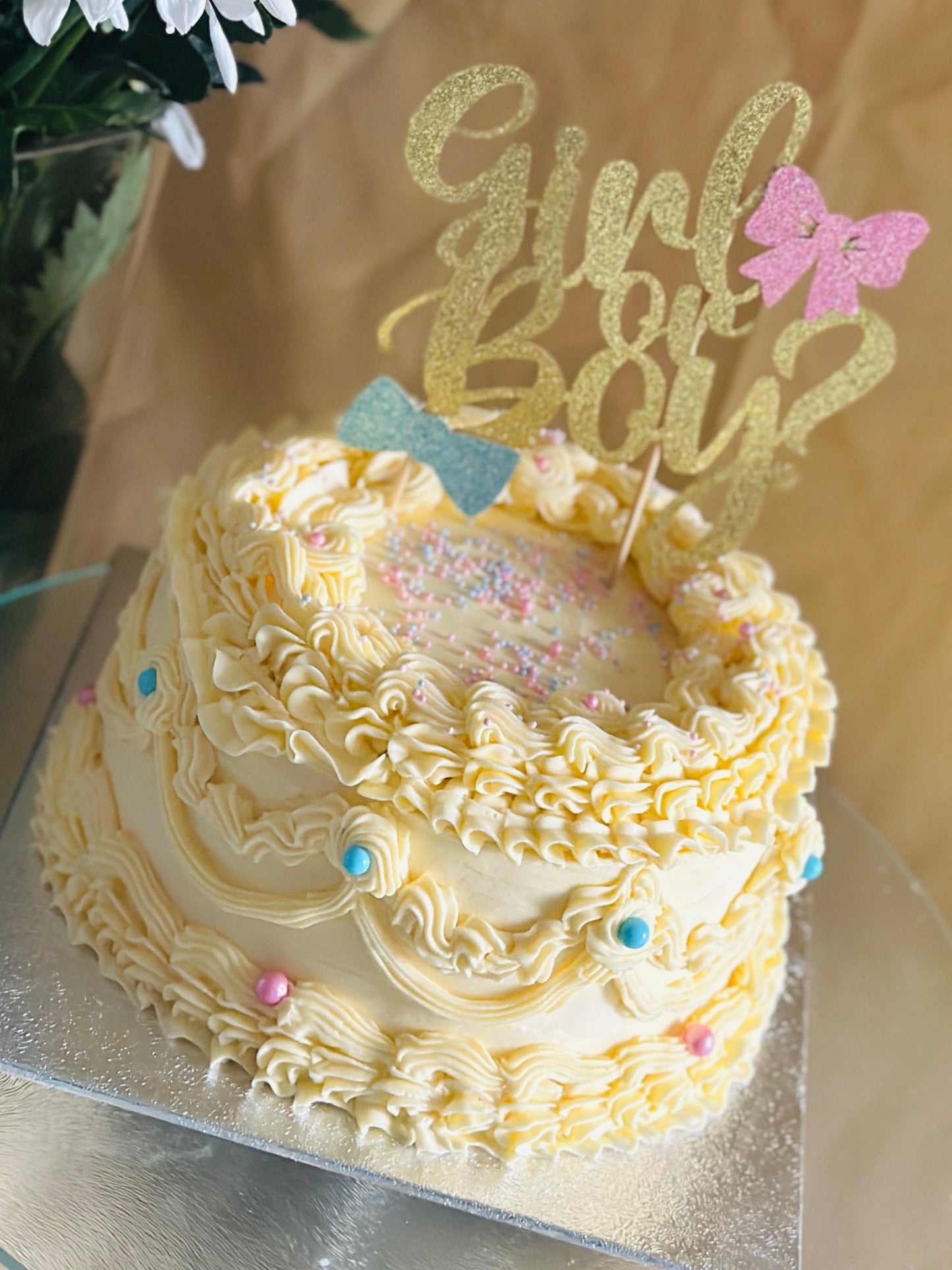 Girl or Boy? buttercream gender reveal cake with gold topper