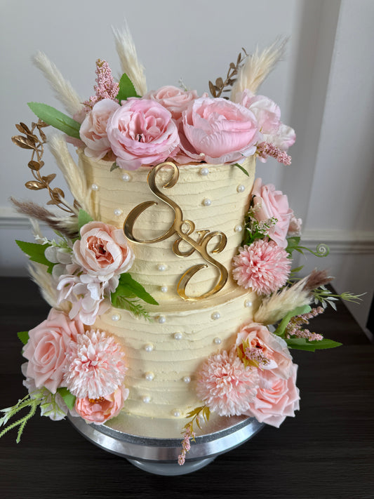 Two tier vintage buttercream wedding cake with hand-piped swags and pearl detailing, baked by Cake Trays for venue delivery across East London