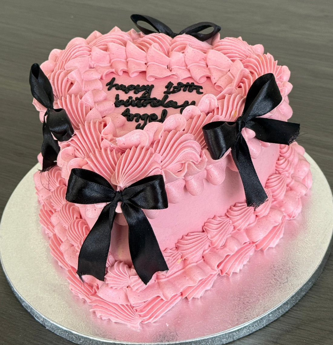 Vintage buttercream heart cake with ivory piping and black ribbon bows, available for same day delivery across Romford and East London