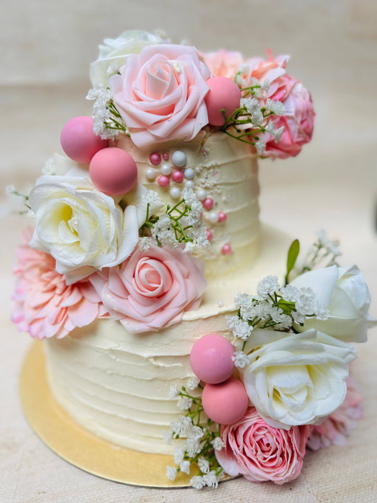 Best floral rose wedding cake available in Woodford and Chigwell – romantic two-tier cake for weddings and engagements.
