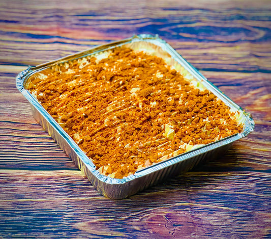 Biscoff Milk Cake Tray in foil pan topped with crushed Biscoff biscuit and caramel drizzle, freshly baked in East London with same-day cake delivery across Romford, Ilford and Dagenham.