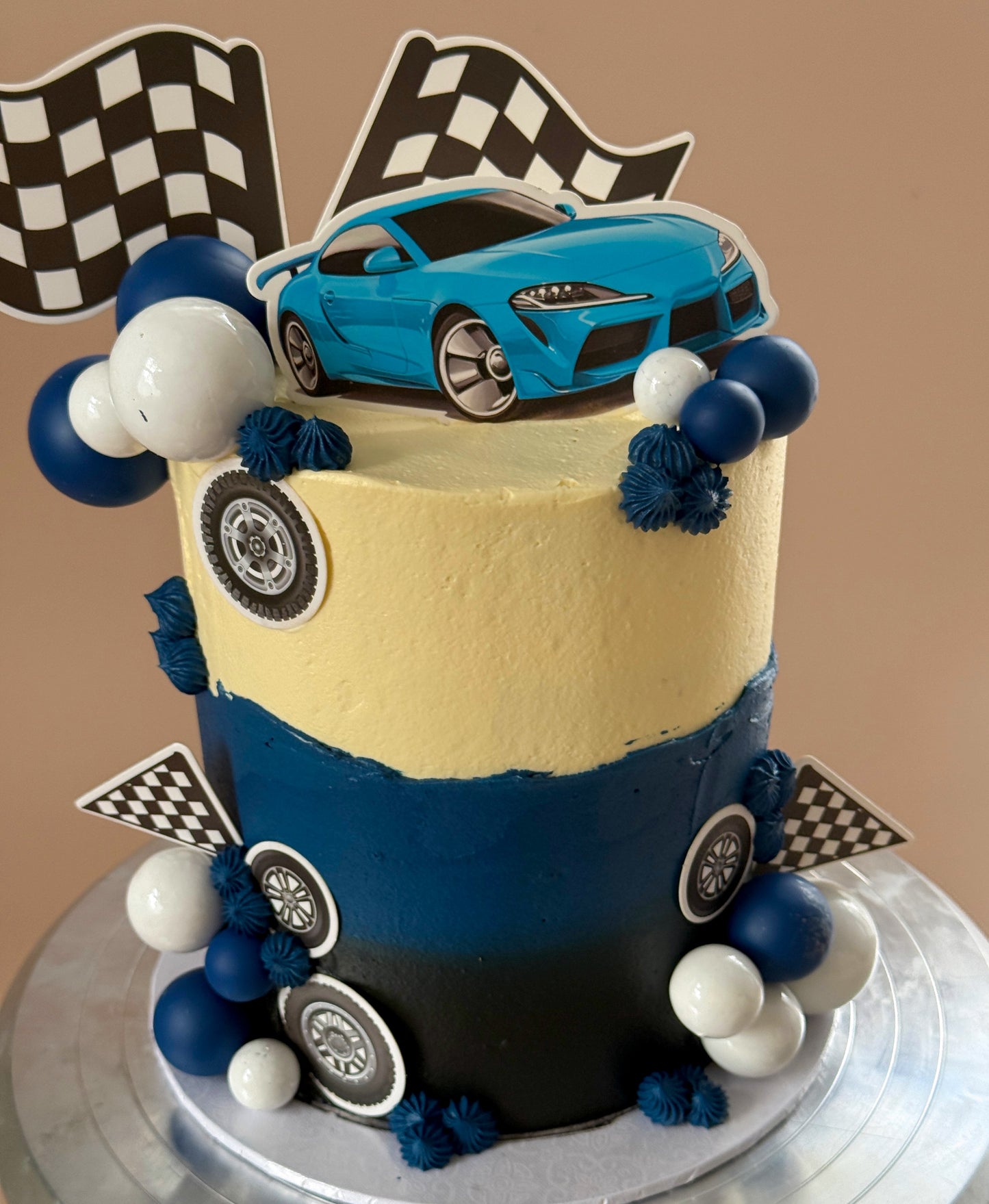 Side view of blue race car birthday cake, custom cakes East London, Romford and Ilford.