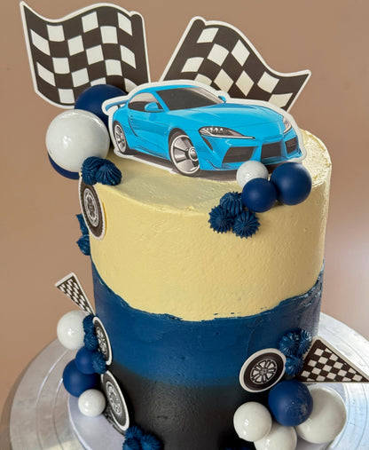 Close up of race car topper and checkered flags on birthday cake, custom cakes East London, Romford and Ilford.