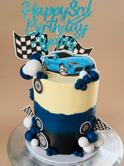 Blue and black race car birthday cake with checkered flags and tyre detailing, custom cakes East London, Romford and Ilford.