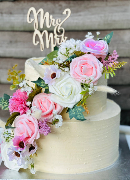 Blush bloom wedding cake decorated with pink and white flowers, available for wedding delivery in Romford and Barking.