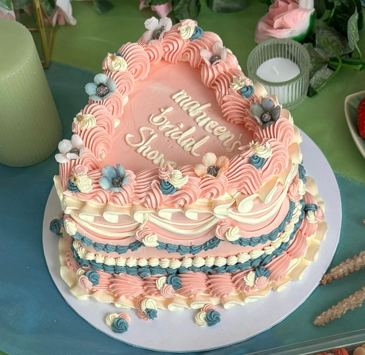 Floral bridal shower heart cake with pink and blue buttercream, available for elegant delivery in Romford and Chigwell.