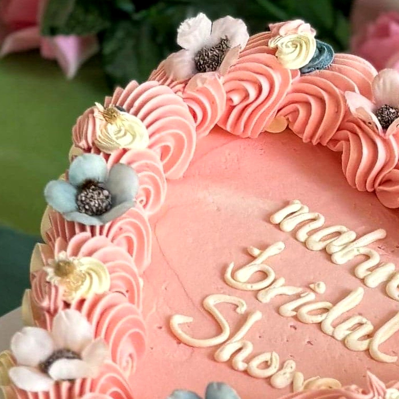 Blue and white dried flowers in pink rope piping on a bridal shower heart cake, delivered in Barking