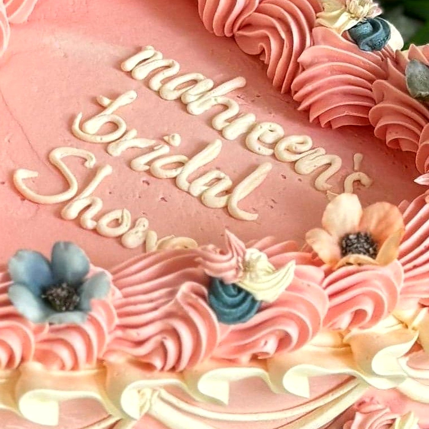 Personalised name hand piped in cream buttercream on a pink heart bridal shower cake, delivered to Walthamstow