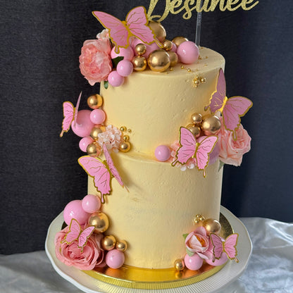 Side view of butterfly first birthday two tier cake, custom cakes East London, Romford and Ilford.