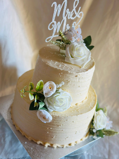 Buy rustic buttercream wedding cake in Ilford and Hainault – elegant two-tier design with fresh floral decorations.