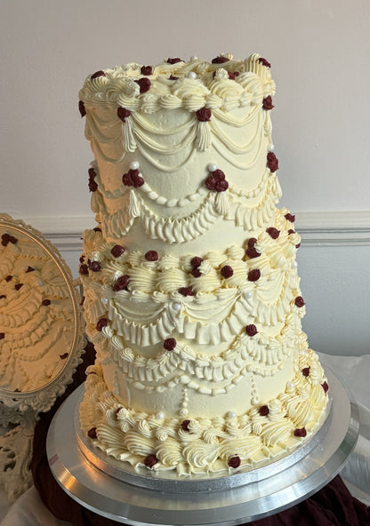 Detailed Lambeth piping and pearl beading on the Vintage Burgundy Pearl Lambeth Two-Tier Wedding Cake with burgundy rose dots, made by Cake Trays for Walthamstow E17 and Leyton E10 delivery.