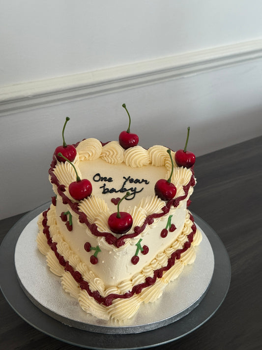 Custom one year celebration heart cake decorated with cherries and vintage buttercream design – available for cake delivery in Barking, Dagenham, and Ilford.