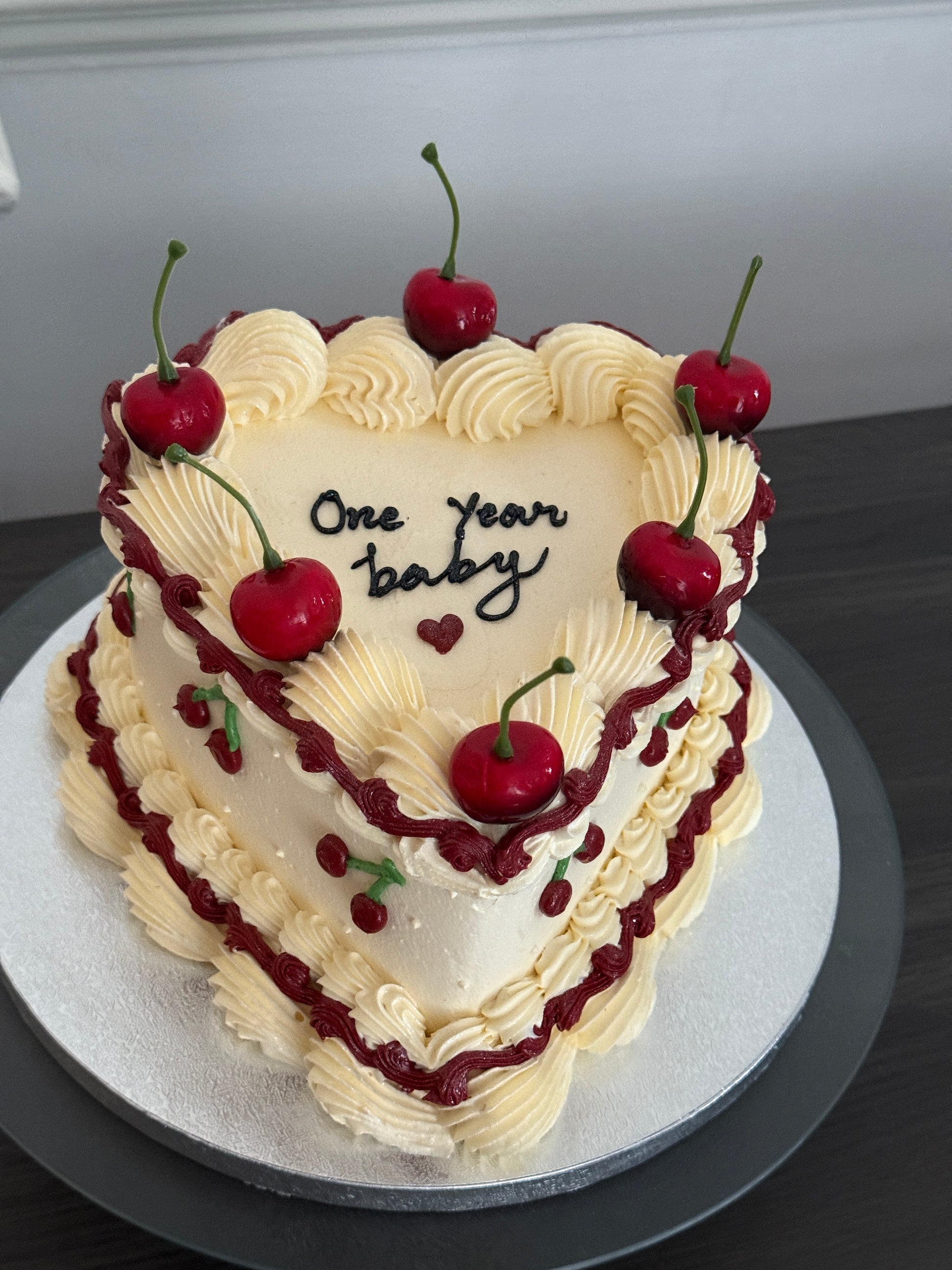 Cherry vintage heart cake with fresh cherries, buttercream piping, and red swirls – available for anniversary and birthday celebrations with same day delivery in Romford, Ilford, and East London.