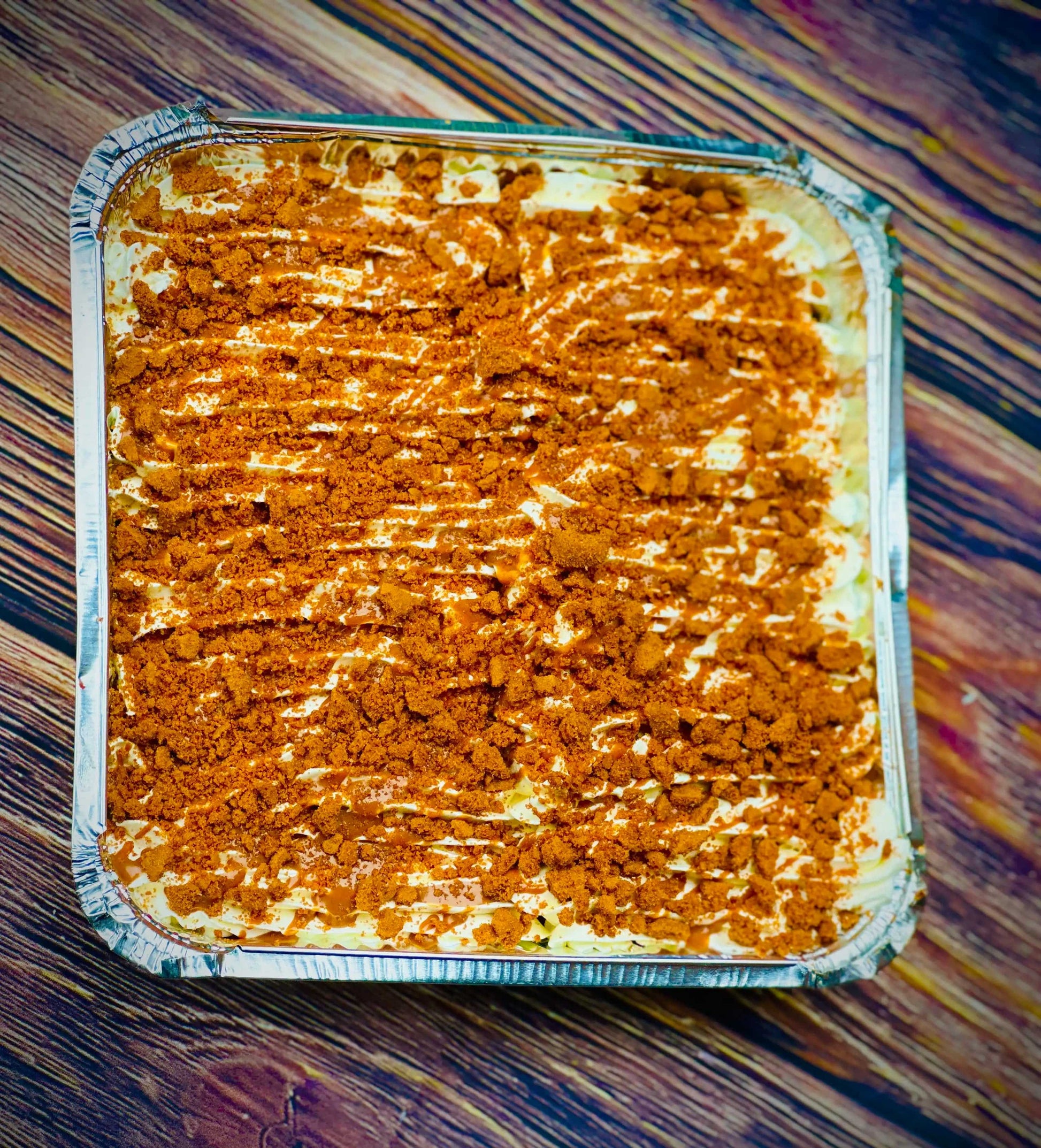 Close-up of Biscoff Milk Cake Tray showing milk-soaked sponge, cream layer and crumbly biscuit topping, available for next day delivery in Barking, East Ham, Chigwell and nearby.