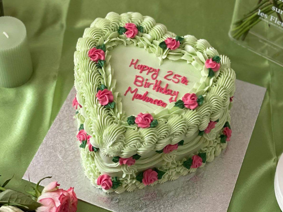 Custom pastel green birthday heart cake decorated with pink roses, handmade for celebrations in Chadwell Heath and Stratford.