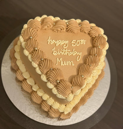 Custom mocha cream heart-shaped cake with elegant piping, delivered to Dagenham and Leyton for birthdays.