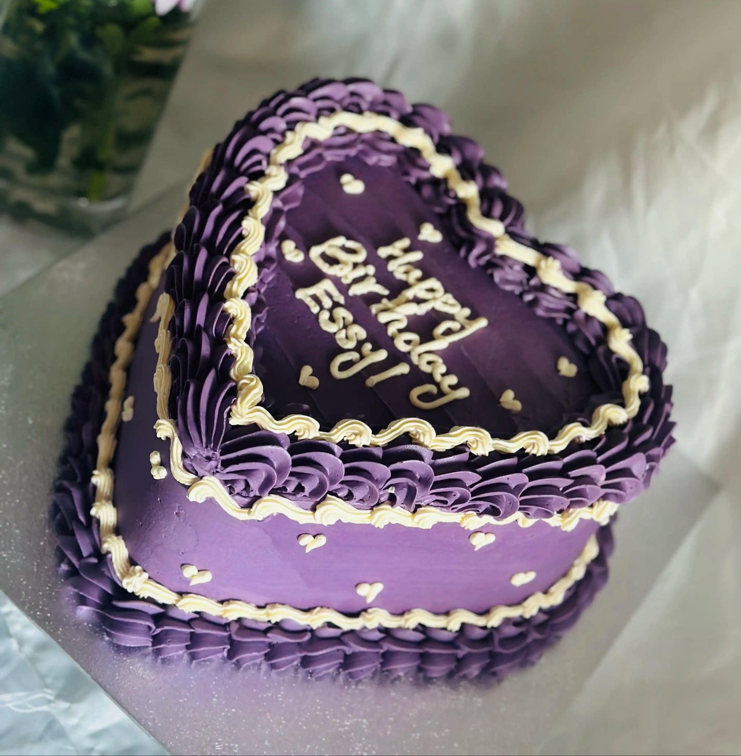 Custom purple heart cake with piped decoration and mini hearts, handmade for birthdays in Romford and Newbury Park.