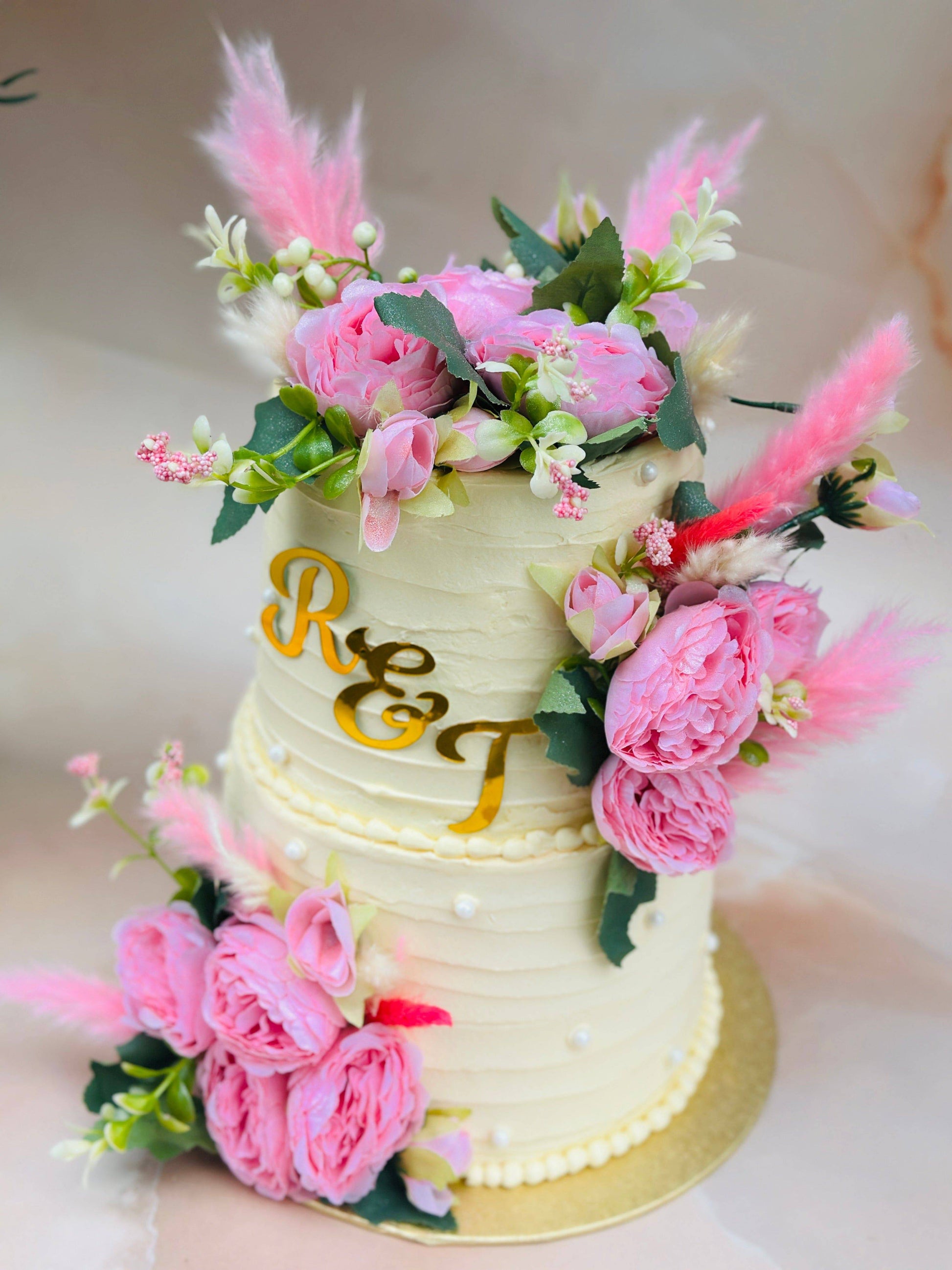 Elegant Floral Wedding Cake with pink flowers and personalised initials, delivered in East London.