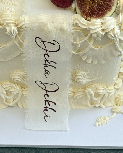 Close up of the Dekha Dekhi calligraphy ribbon and Lambeth piping, custom cakes East London, Romford and Ilford.