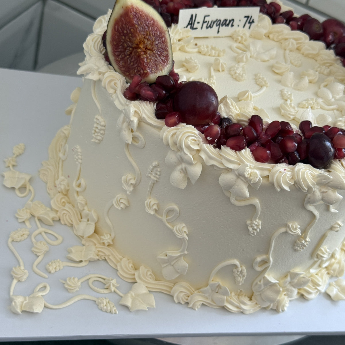 Close up of the hand piped vines and pomegranate crown, custom cakes East London, Romford and Ilford.