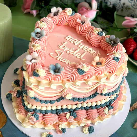 Pink heart shaped bridal shower cake with vintage piping and dried flowers, made in East London