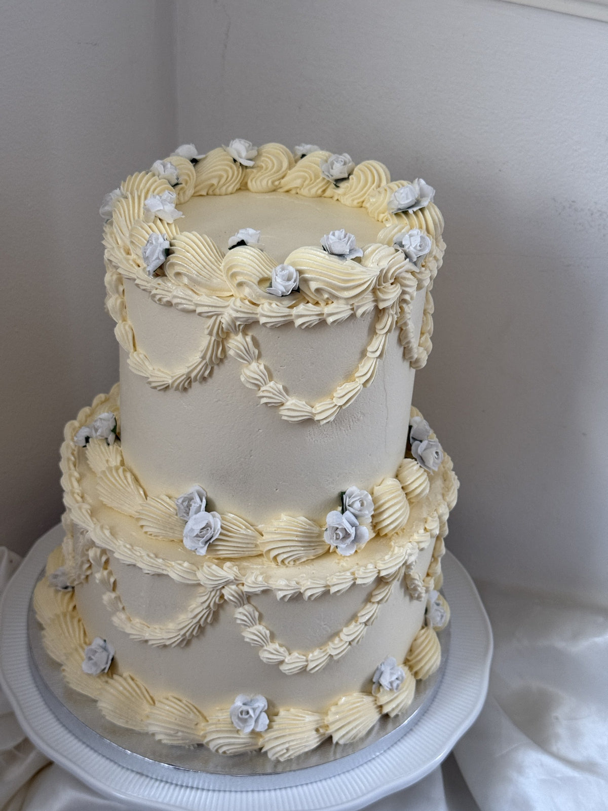 Two-tier ivory Lambeth cake with shell borders and swags, custom cakes East London, Romford and Ilford.