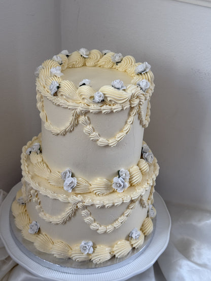 Two-tier ivory Lambeth cake with shell borders and swags, custom cakes East London, Romford and Ilford.