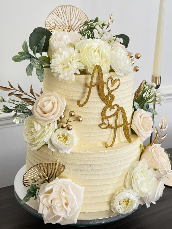 Ivory and gold initials two-tier wedding cake delivered to Barley Lane, Goodmayes