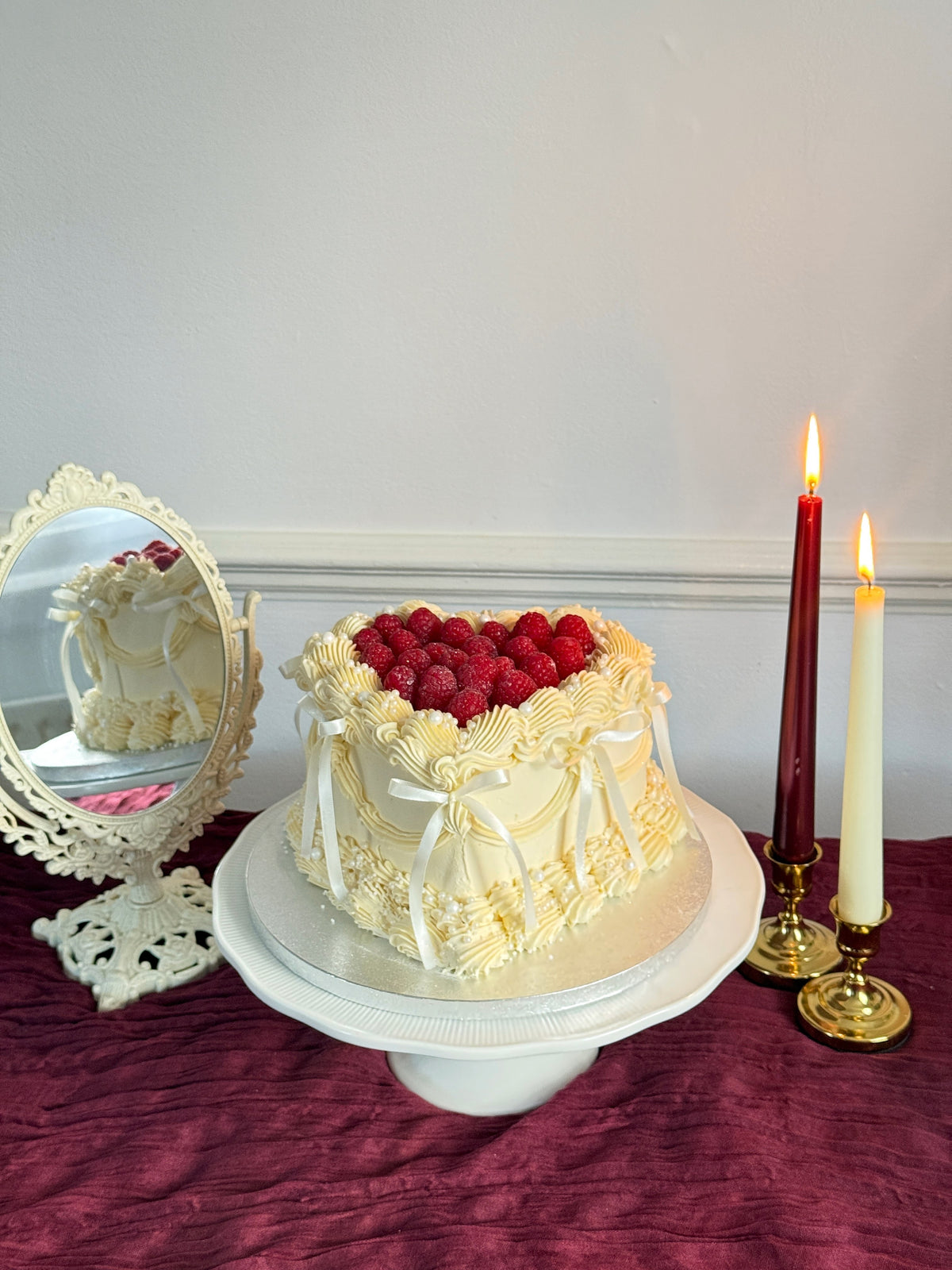 Side view of ivory Lambeth heart cake with raspberries, custom cakes East London, Romford and Ilford.