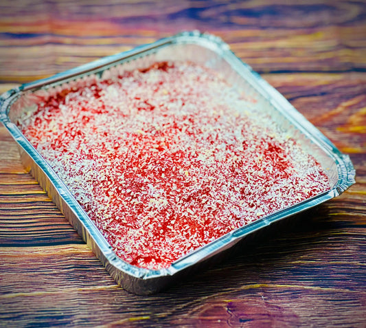 Jam and coconut tray bake with vanilla sponge, strawberry jam and desiccated coconut, available for same day delivery in Romford and Ilford, East London.