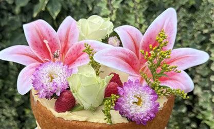 Close up of pink lilies, asters and rose on top of the naked cake, custom cakes East London, Romford and Ilford.