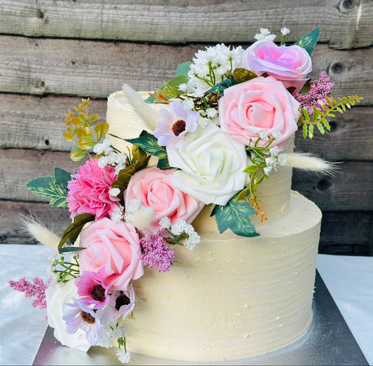 Luxury blush bloom wedding cake in Dagenham and Walthamstow – two-tier design with roses and floral arrangement.
