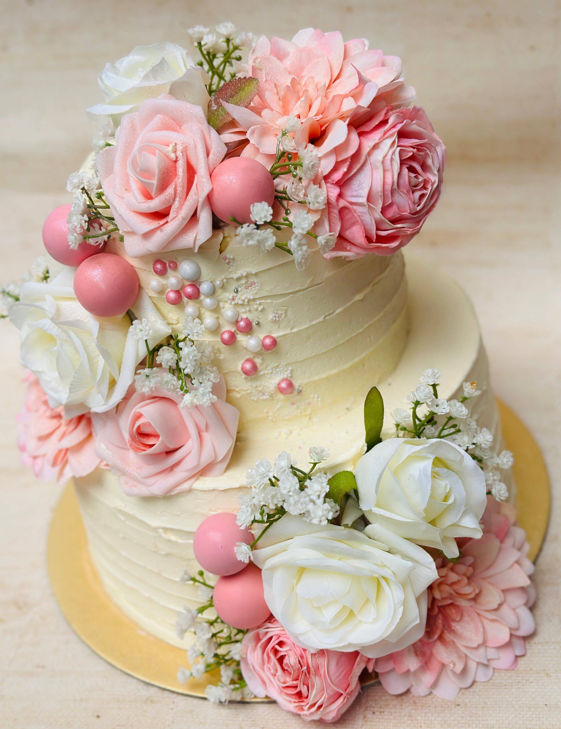 Luxury rose wedding cake with pearl details and floral decorations, handmade for couples in Dagenham and East London.