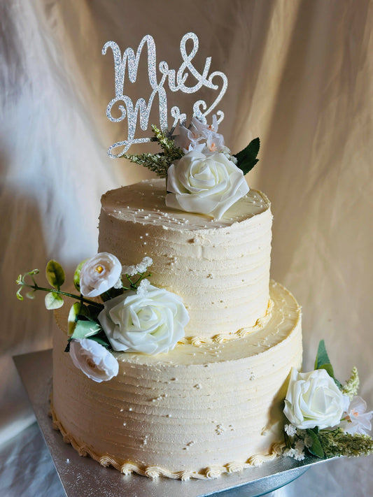 Luxury rustic chic wedding cake featuring white roses and greenery, crafted for couples in Barking and Chigwell.