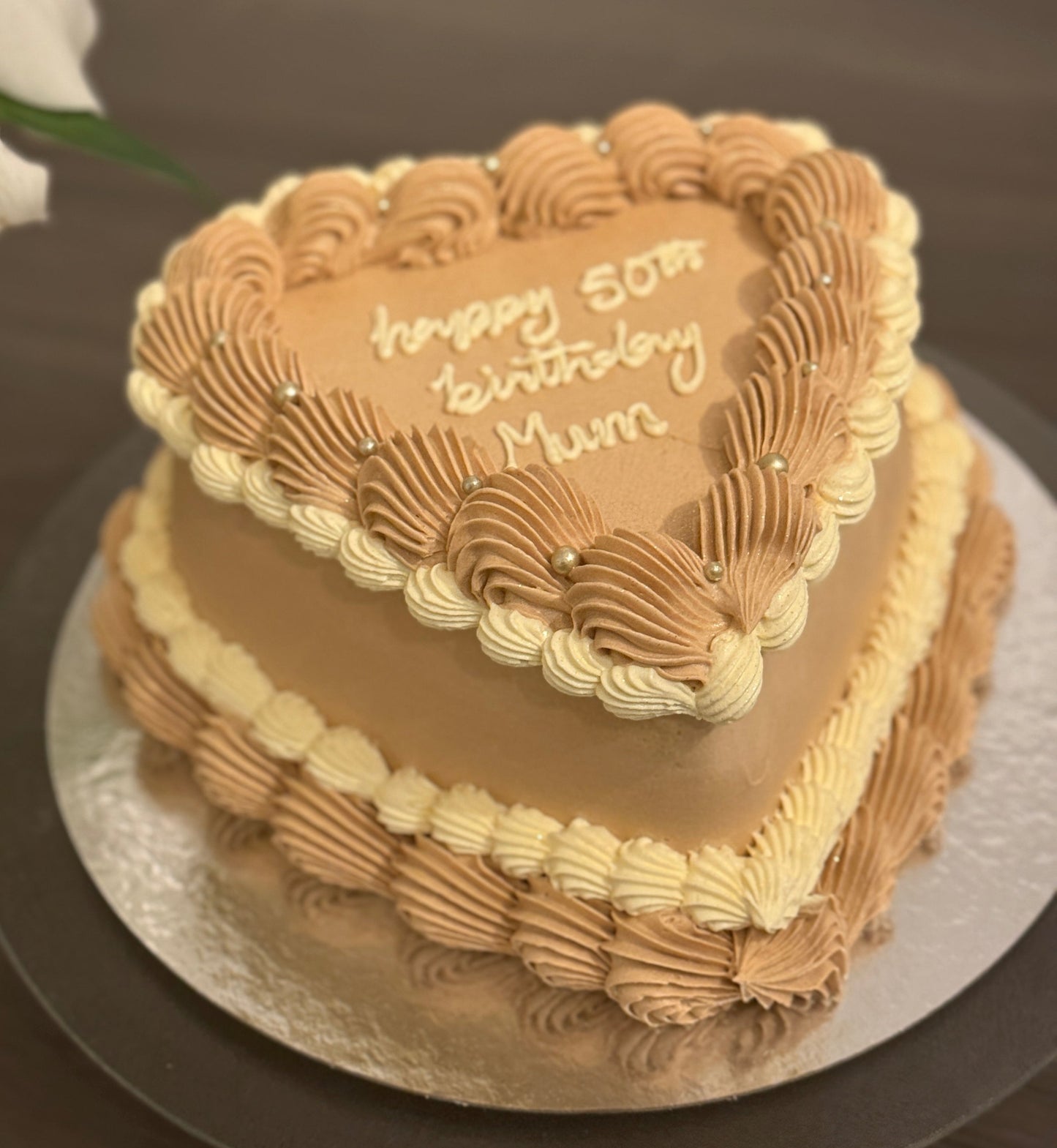 Mocha cream birthday heart cake decorated with buttercream swirls, perfect for Chigwell and Stratford celebrations.