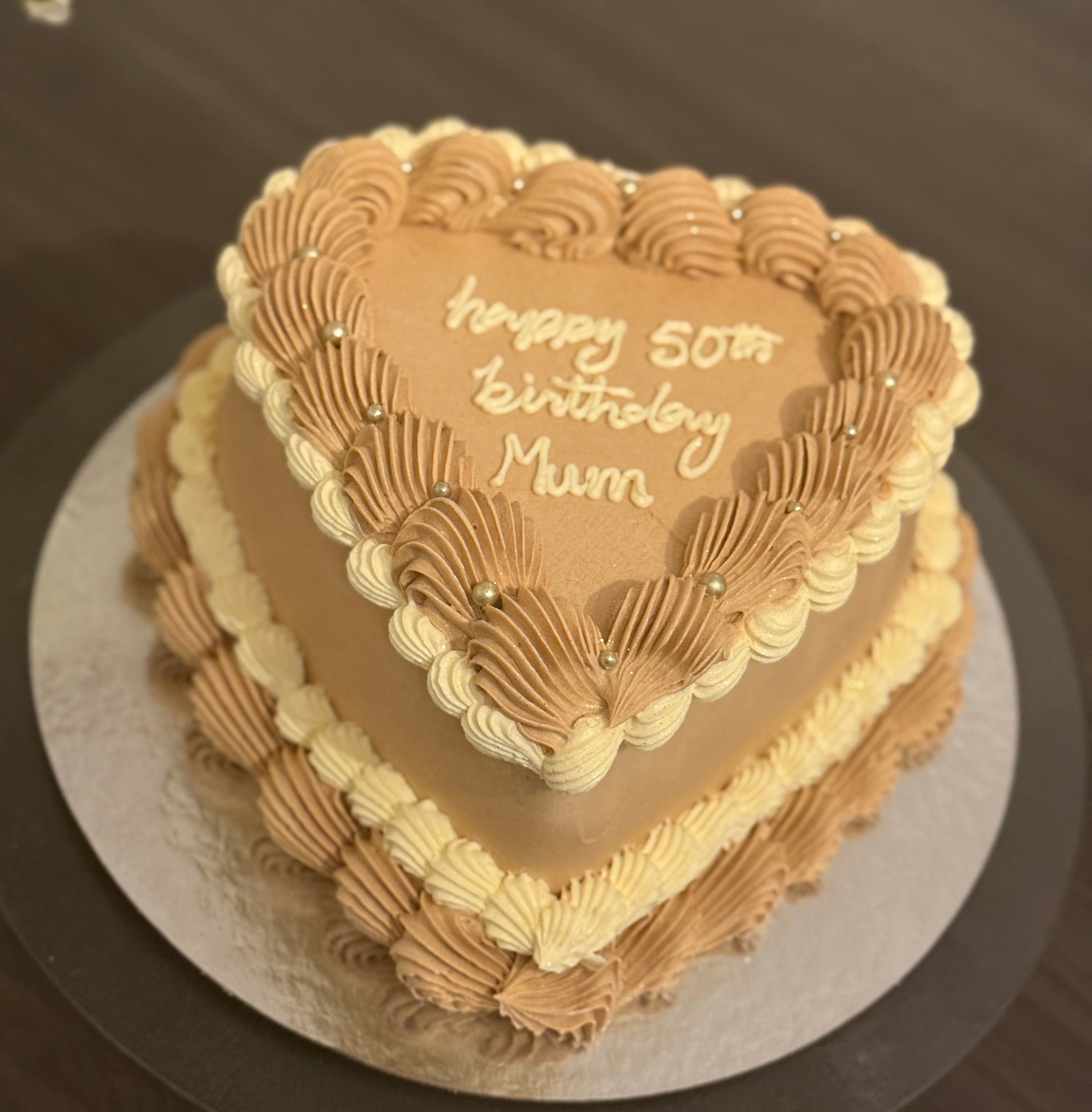 Mocha cream heart birthday cake with piped design, available for delivery in Romford and Goodmayes.