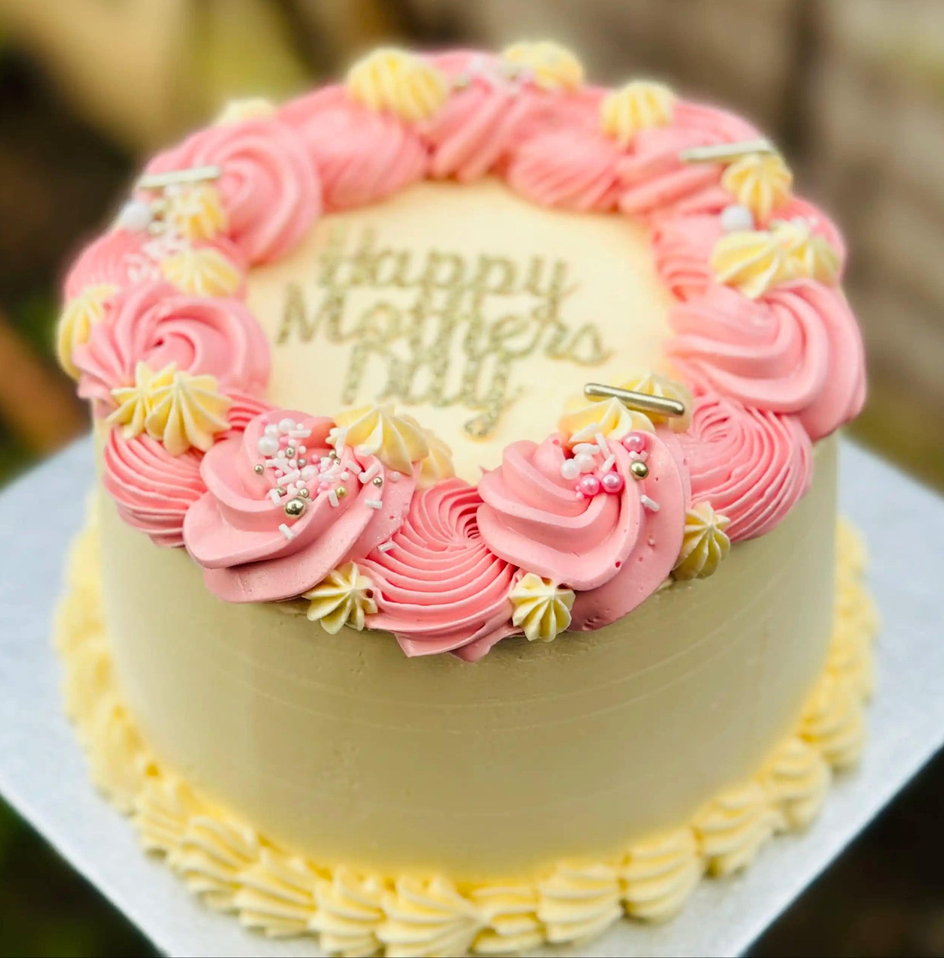 Mother’s Day cake with pink buttercream swirls and sprinkles, available for delivery in Romford and East Ham.