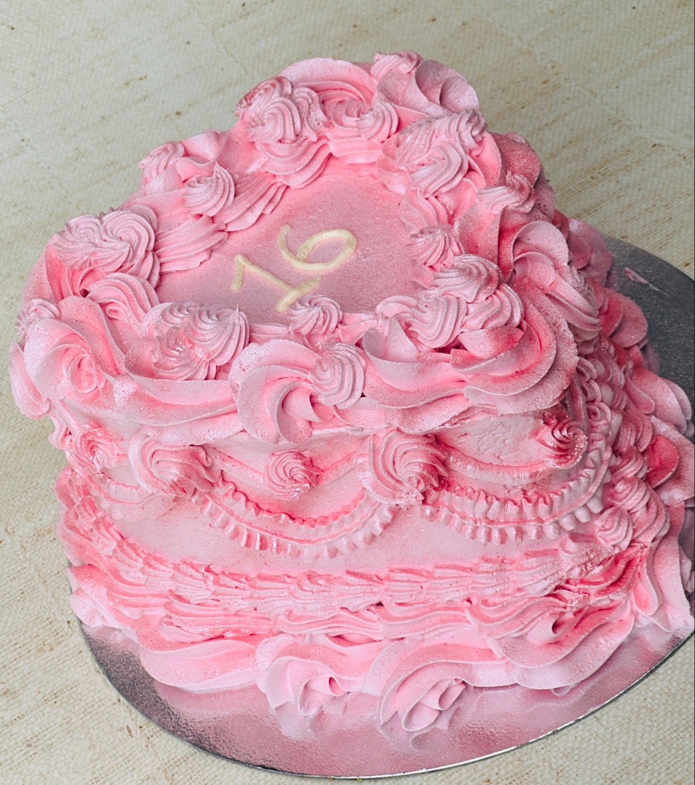 Order sweet 16 heart birthday cake online with delivery in Dagenham and East London – elegant pink design with piping.
