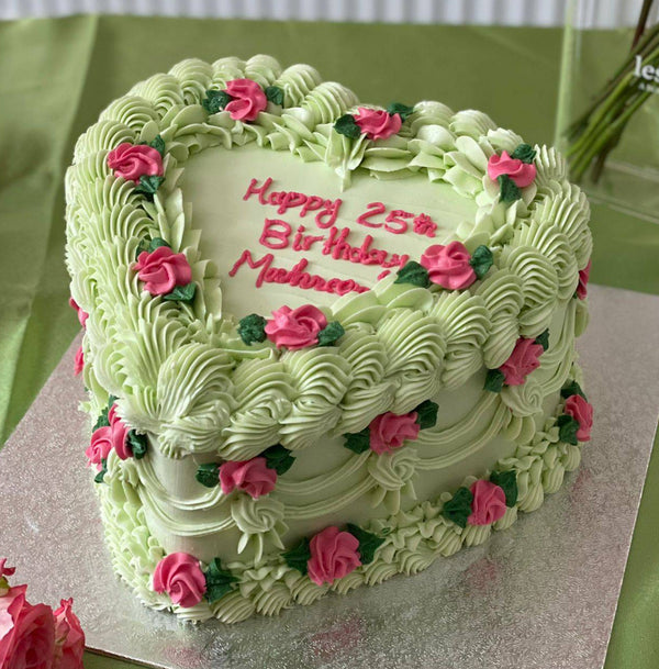 Pastel green heart birthday cake with piped buttercream roses, available for delivery in Romford and Upton Park.