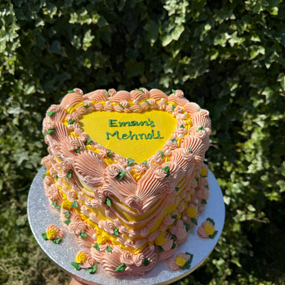 Top-down view of the peach piping and lemon heart top of the mehndi cake — custom cakes East London, Romford and Ilford.