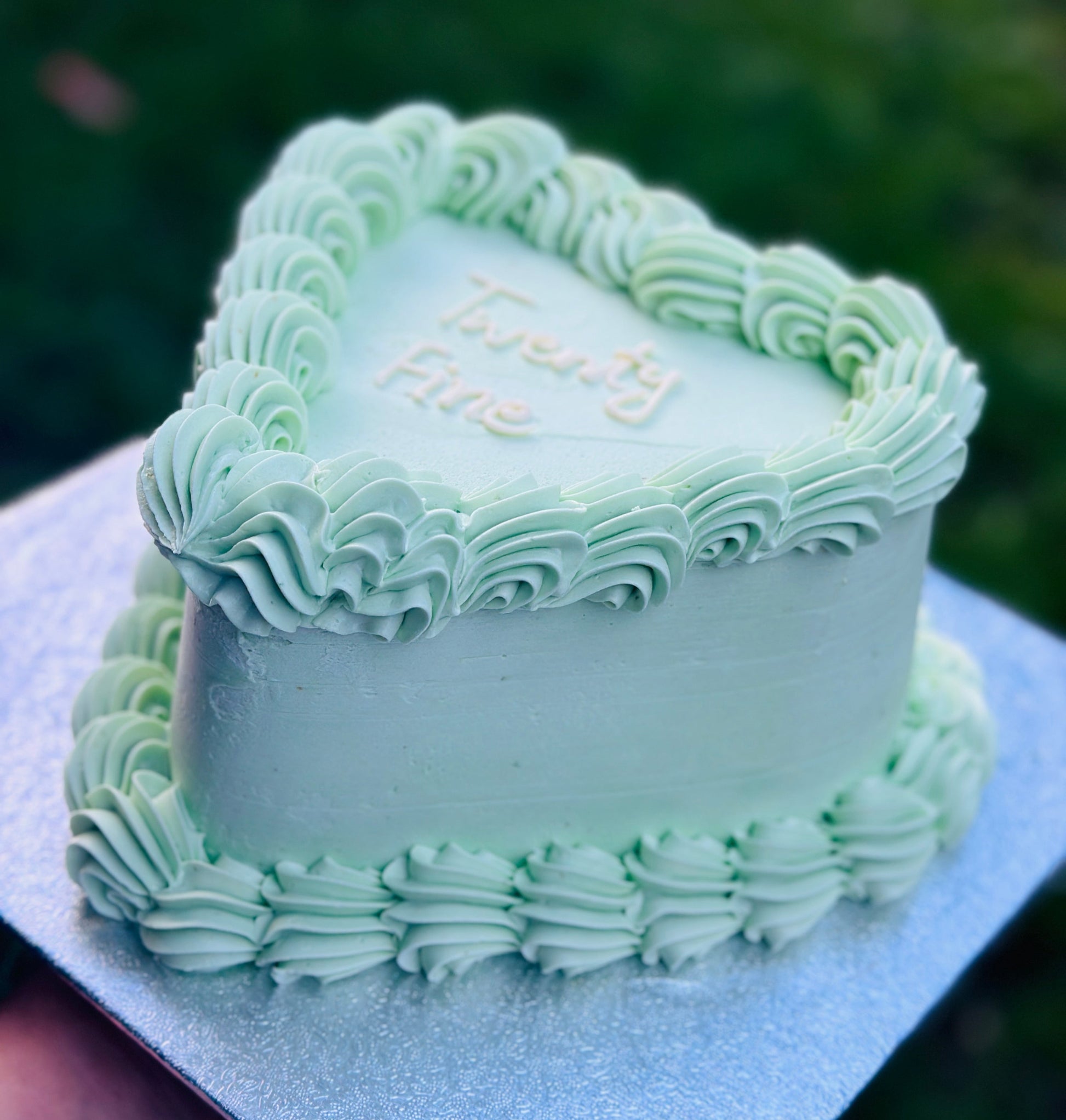 Personalised heart cake with custom writing and floral detailing, delivered in Chigwell and Manor Park.