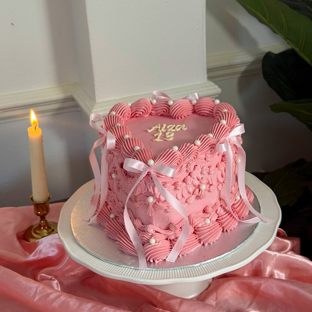Side view of pink Lambeth heart bow cake, custom cakes East London, Romford and Ilford.