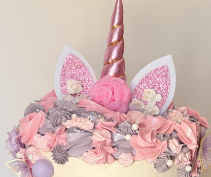 Close up of the rose gold unicorn horn, glitter ears and buttercream rosettes, custom cakes East London, Romford and Ilford.