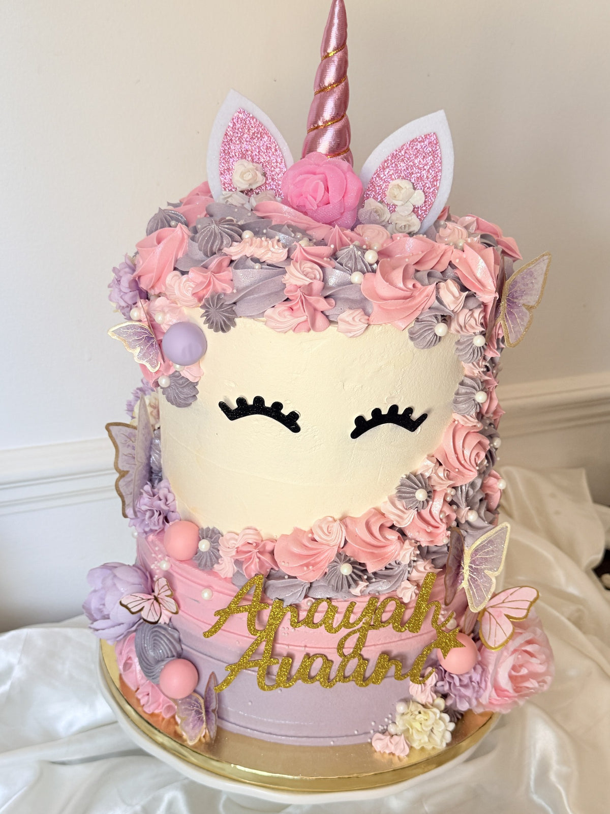 Extra tall pink and lilac unicorn birthday cake with rose gold horn and glitter name topper, custom cakes East London, Romford and Ilford.