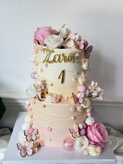 Full view of the pink rose and butterfly first birthday cake on its board, custom cakes East London, Romford and Ilford.